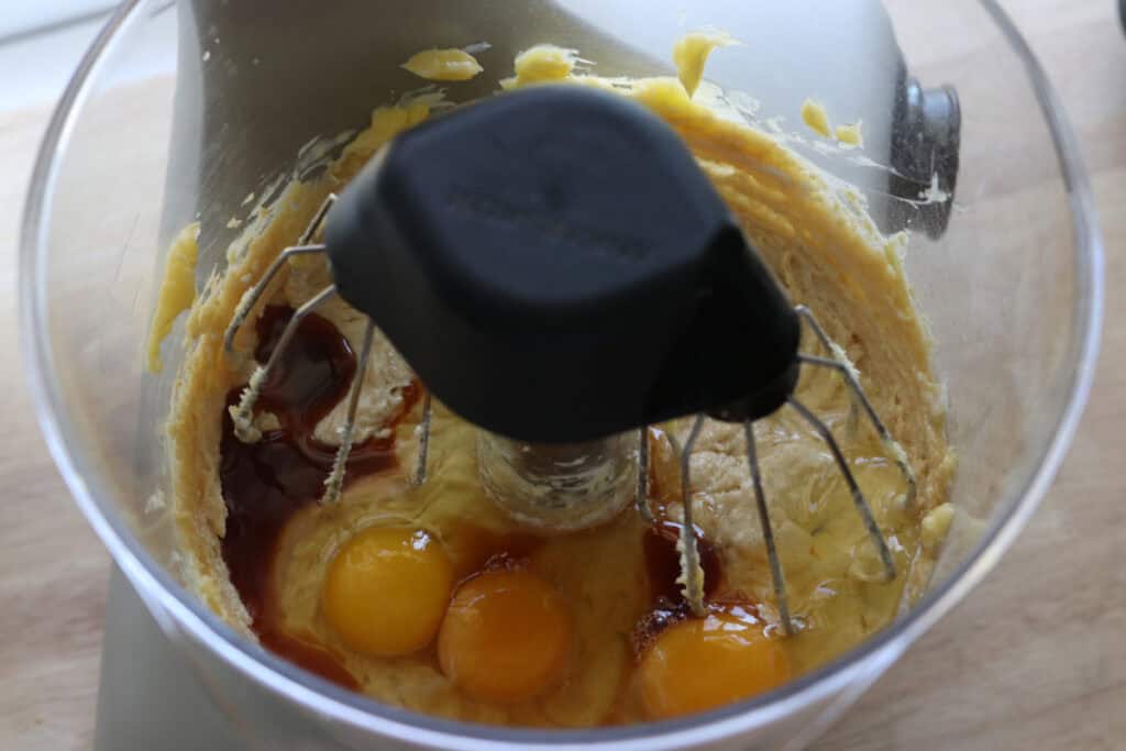 eggs added to a mixing bowl to make Fresh Milled Little Debbie Christmas Tree Cakes