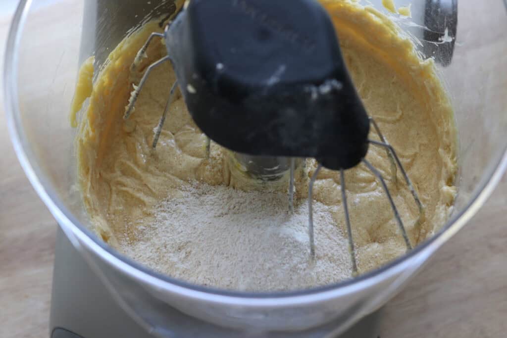 fresh milled flour added to a mixing bowl to make Fresh Milled Little Debbie Christmas Tree Cakes