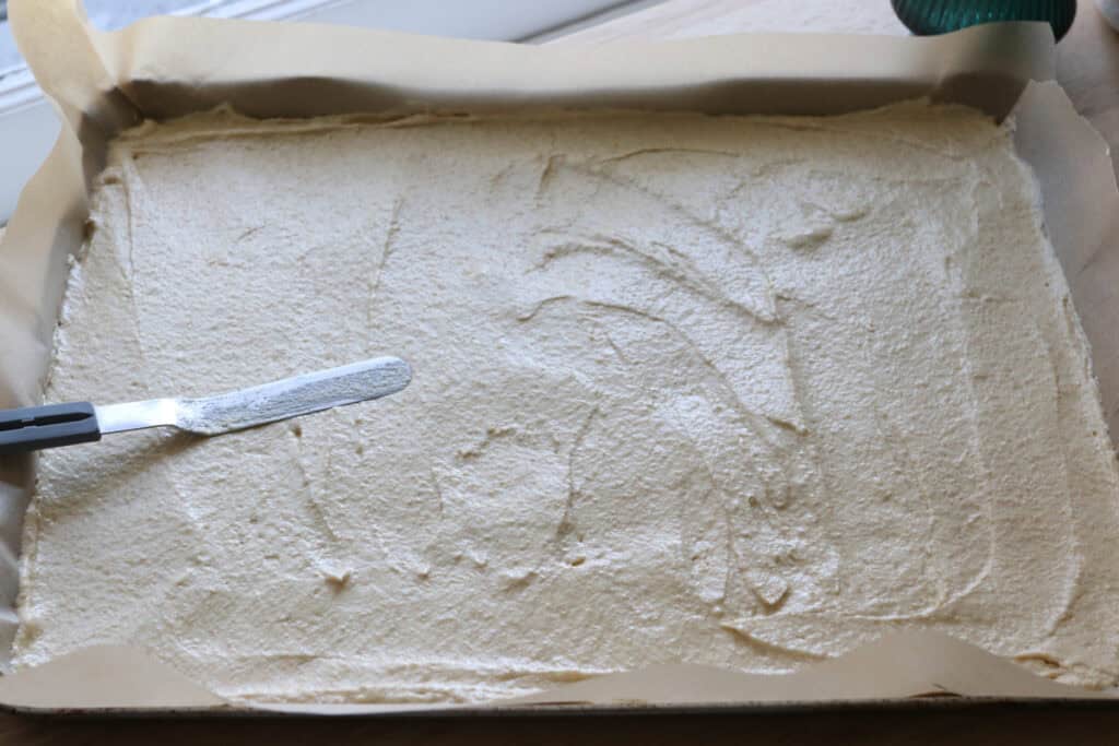 Fresh Milled Little Debbie Christmas Tree Cake batter spread out on a baking sheet