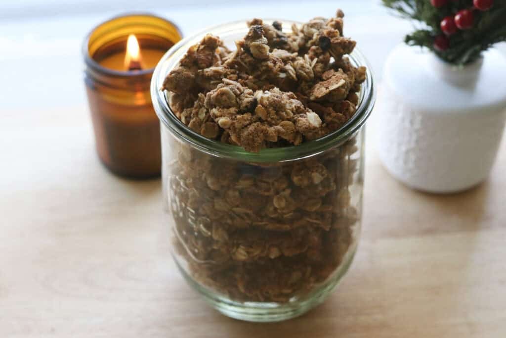 Healthy and Crunchy Protein-Packed Granola in a glass jar with a candle