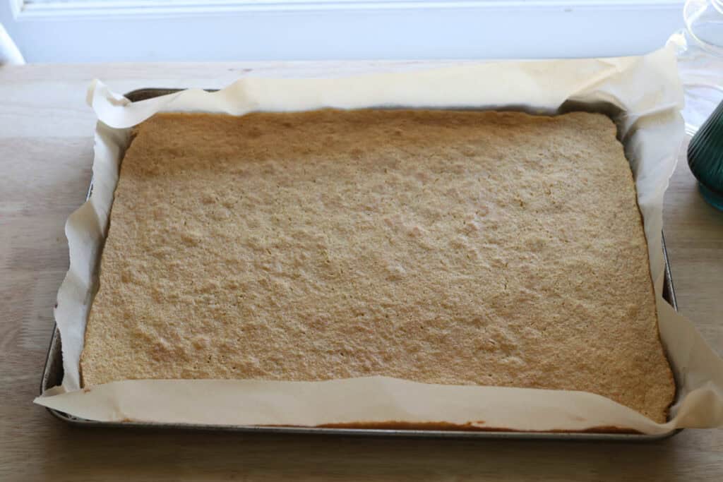 Fresh Milled Little Debbie Christmas Tree Cake on a baking sheet that has been cooked