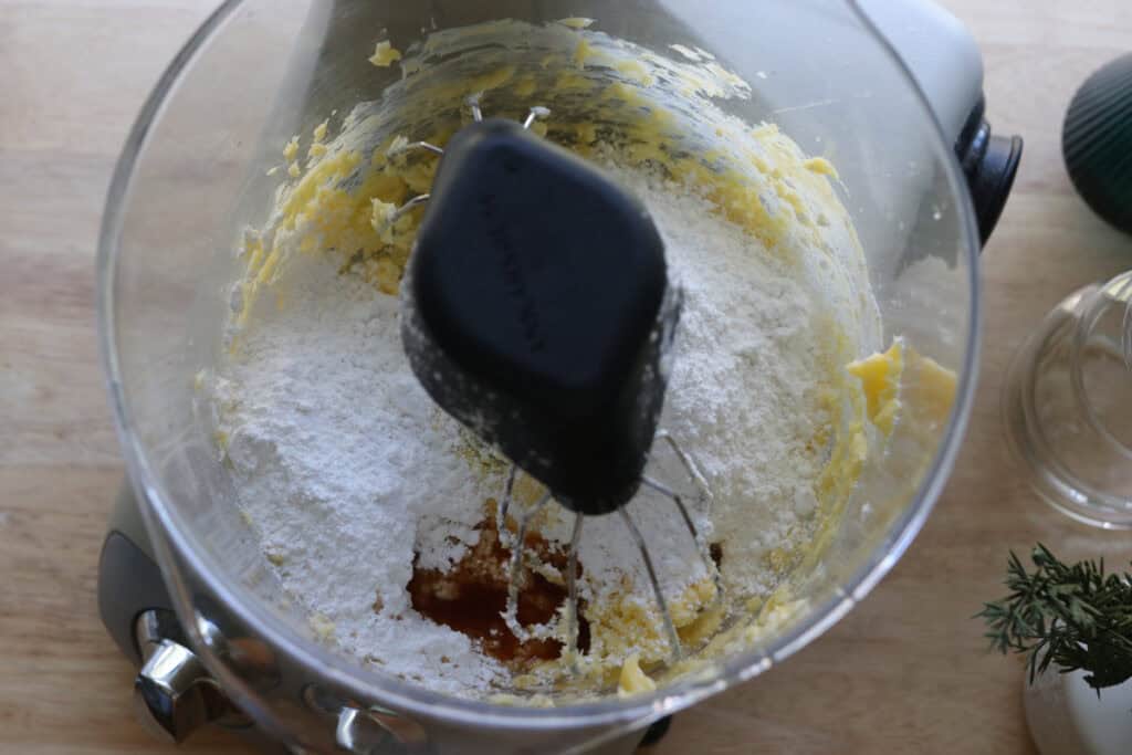 powdered sugar and vanilla in a bowl to make the icing for Fresh Milled Little Debbie Christmas Tree Cakes