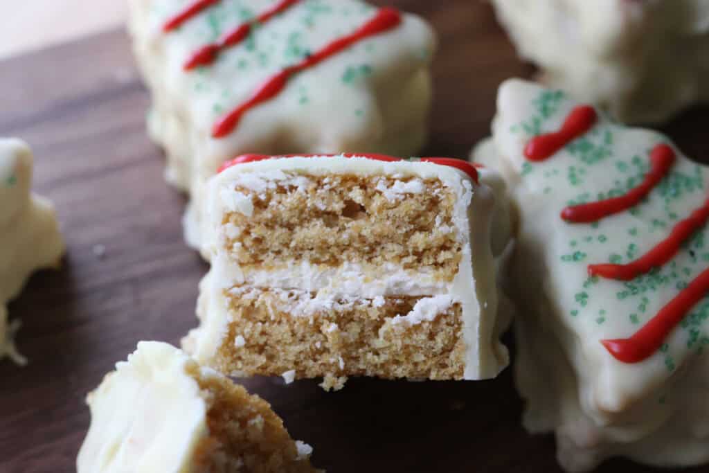 a Fresh Milled Little Debbie Christmas Tree Cakes that has been cut in half with icing in the middle