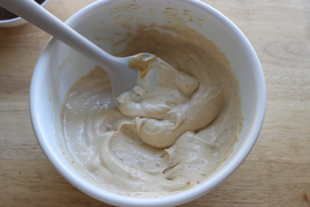 High Protein Chocolate Peanut Butter Yogurt stirred together in a white bowl 