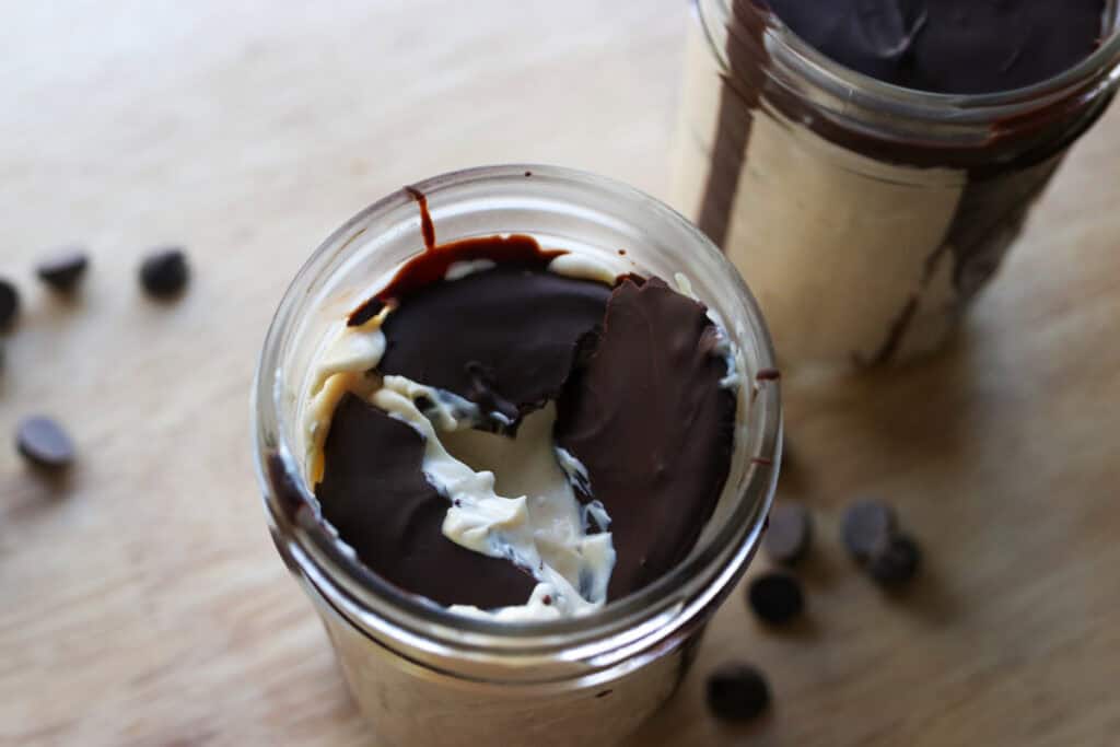 High Protein Chocolate Peanut Butter Yogurt Cups with a chocolate shell that has been cracked