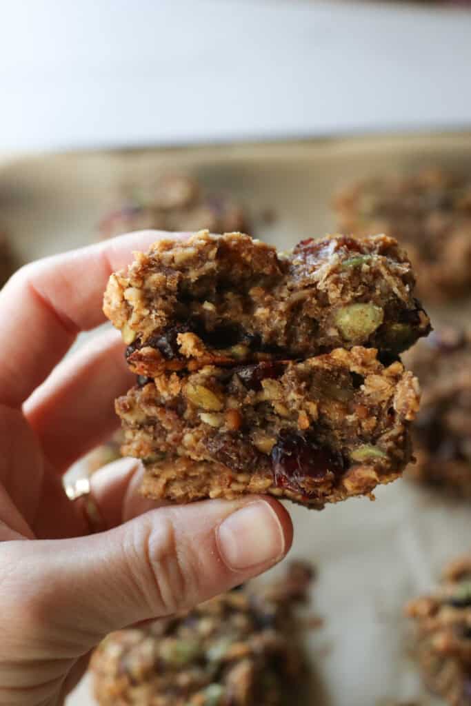 someone holding a Easy and Healthy Breakfast Oatmeal Cookie that is split in half