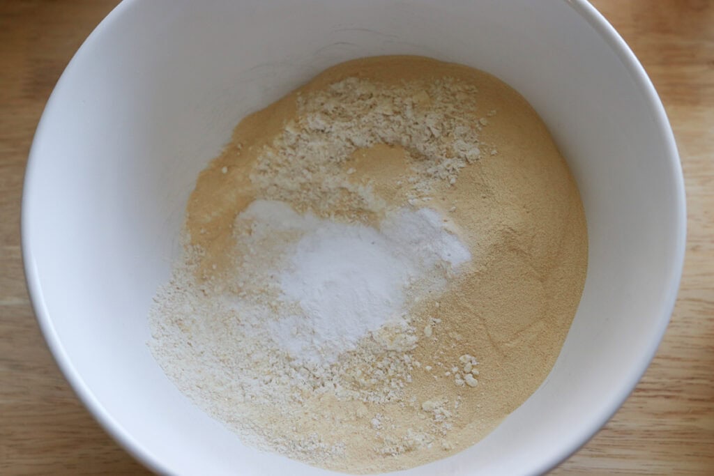 protein powder and flour in a white bowl to make fresh milled sheet pan protein pancakes