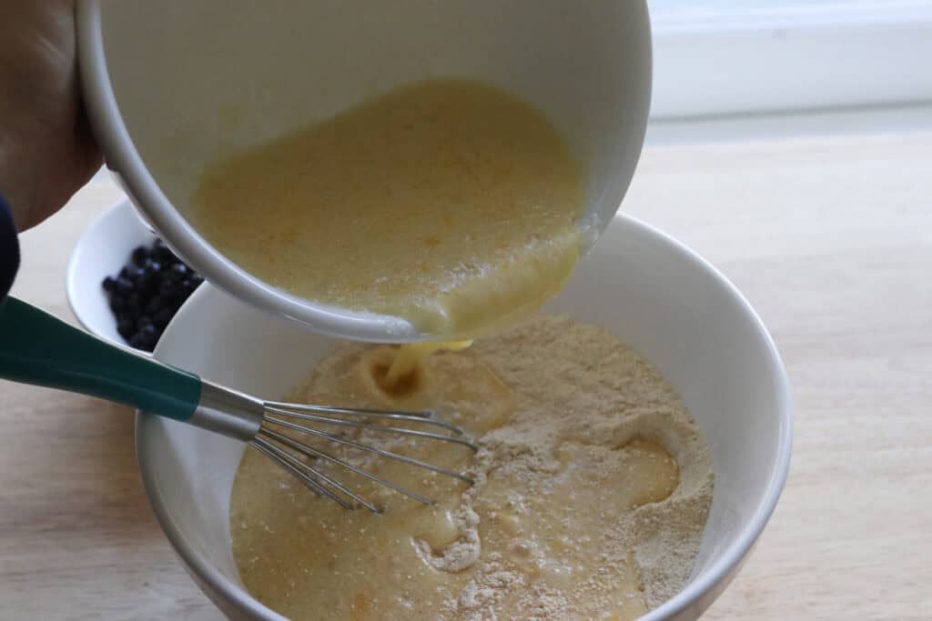 pour the wet ingredients into the dry ingredients to make fresh milled sheet pan protein pancakes