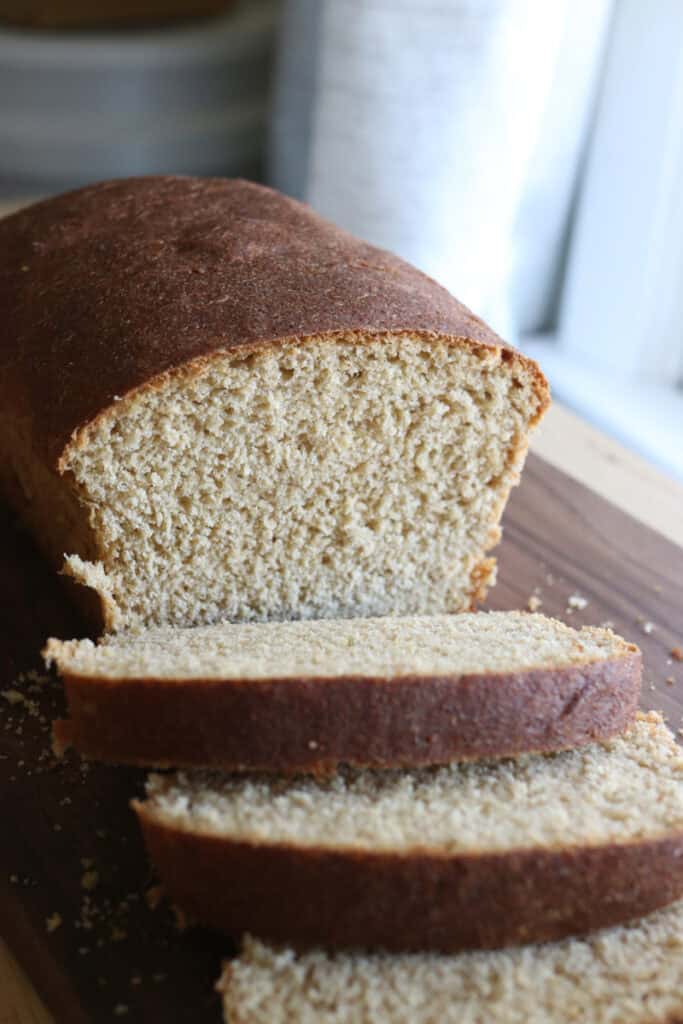 a loaf of fresh milled sandwich bread using the tangzhong method on a cutting board