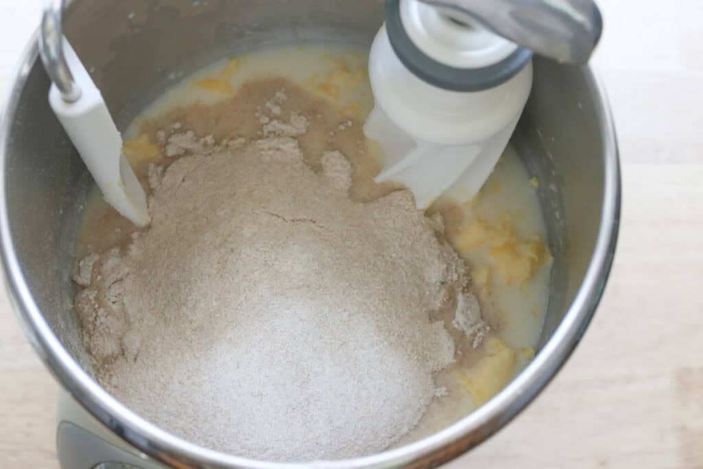 flour added to a mixing bowl to make freshly milled english muffins