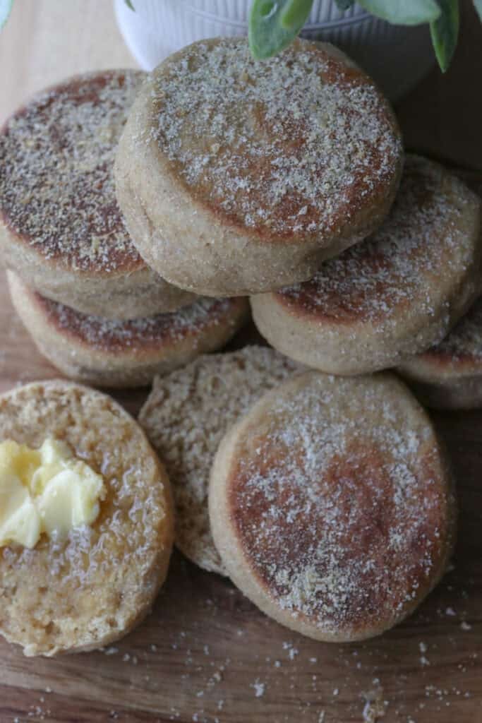 freshly milled english muffins that have been stacked together on a wooden board