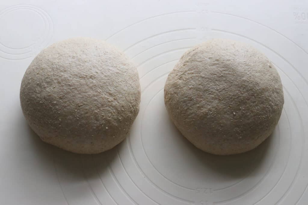 freshly milled soup bread bowl dough shaped into two balls