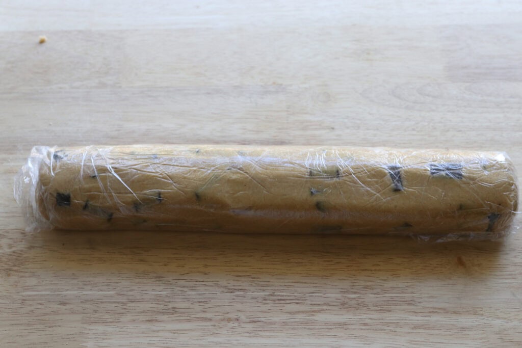 Freshly Milled Slice and Bake Chocolate Chunk Cookie dough that has been wrapped in plastic wrap 