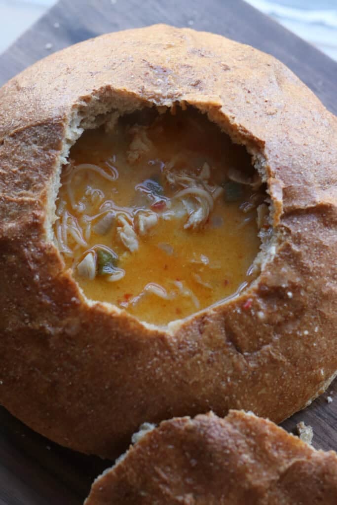 a freshly milled soup bread bowl filled with chicken soup