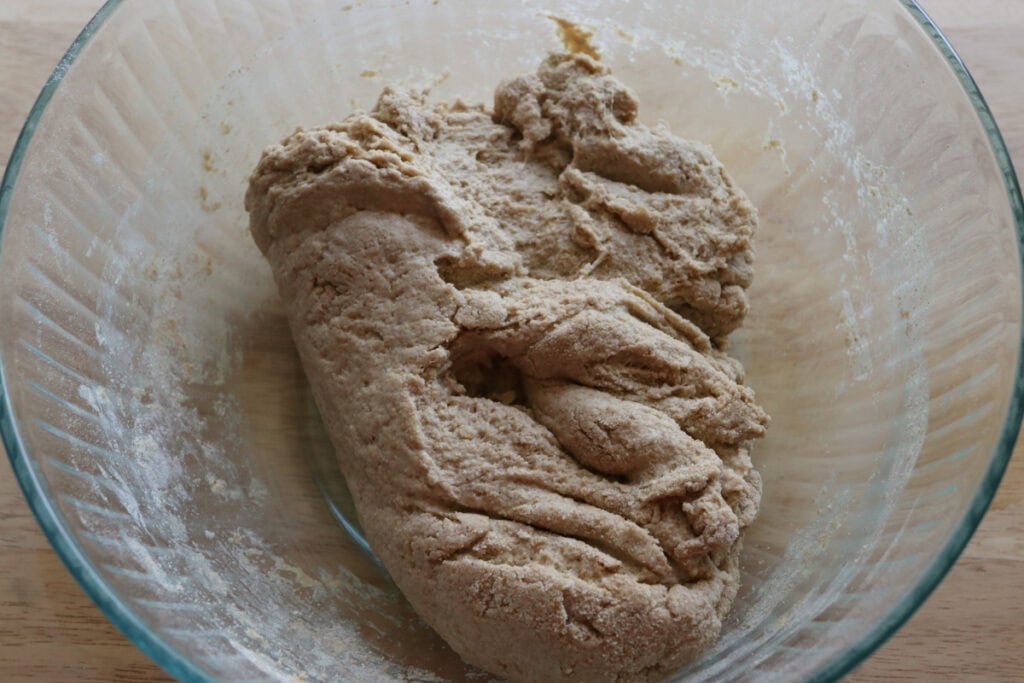 dough in a glass bowl that is rising 