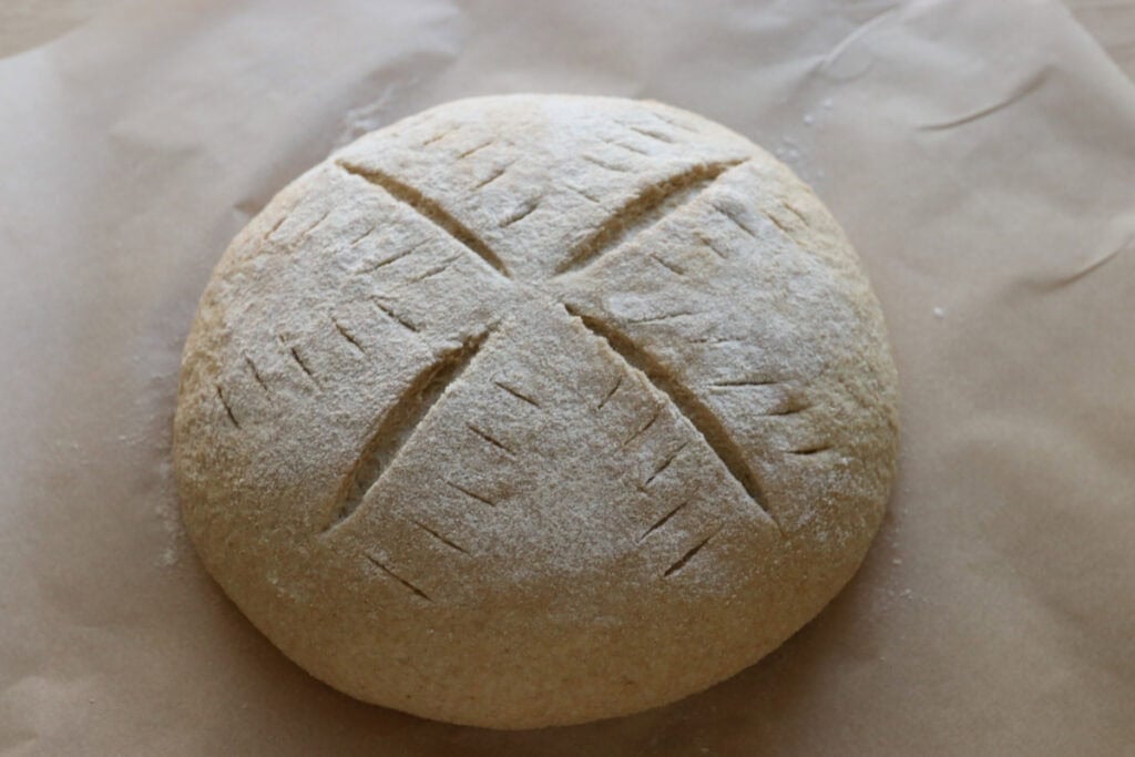 fresh milled artisan loaf that has been floured and scored
