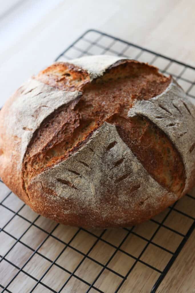the best fresh milled artisan loaf cooling on a wire rack