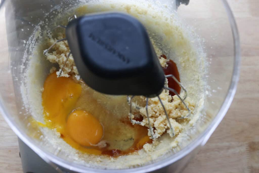 eggs and vanilla added to a mixing bowl to make freshly milled red velvet cupcakes