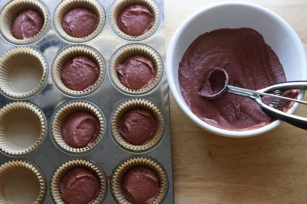 freshly milled red velvet cupcake batter in a cupcake pan