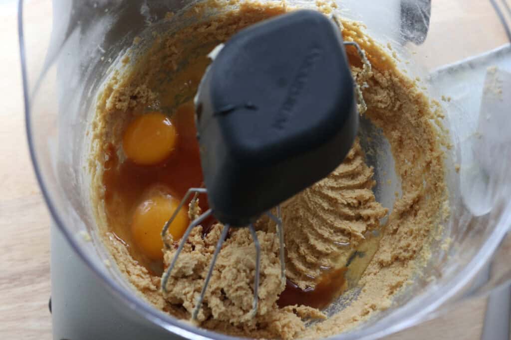 eggs and vanilla added to a mixing bowl to make freshly milled chocolate chip biscotti