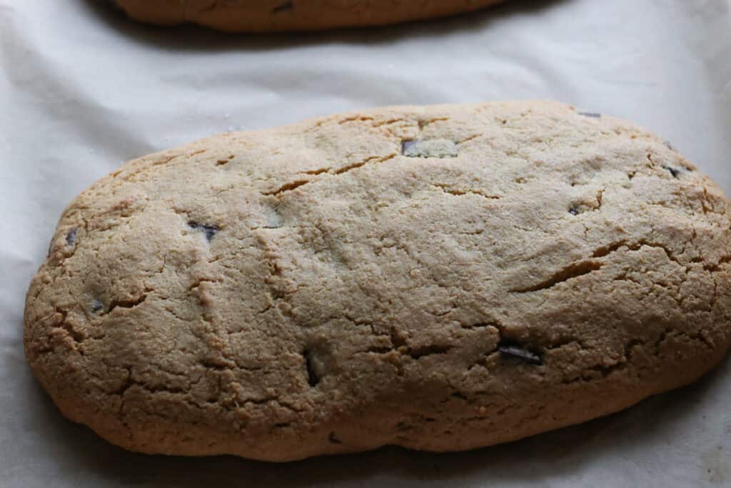 freshly milled chocolate chip biscotti that has been baked on a piece of parchment paper