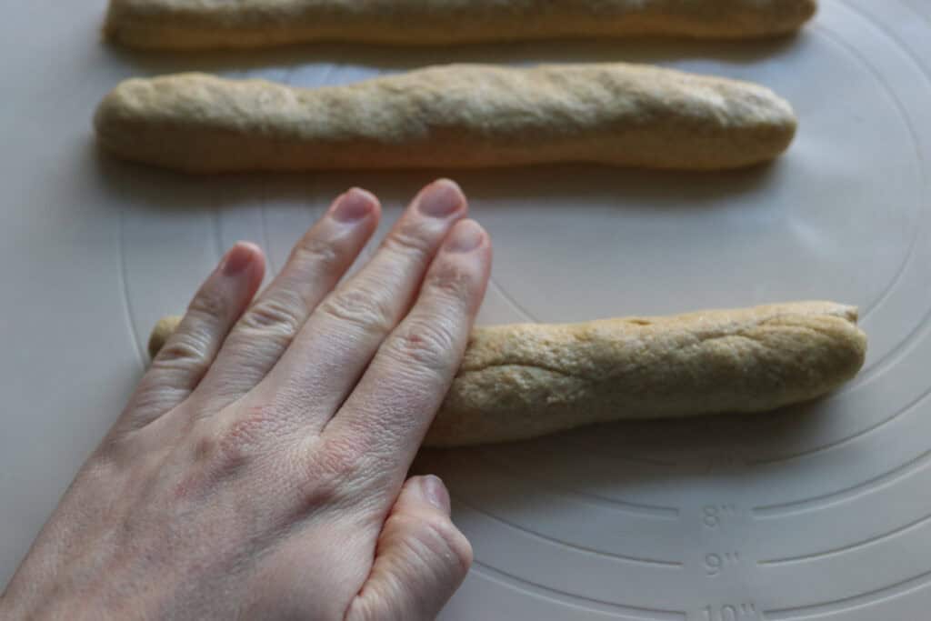 rolling fresh milled sourdough into a breadstick