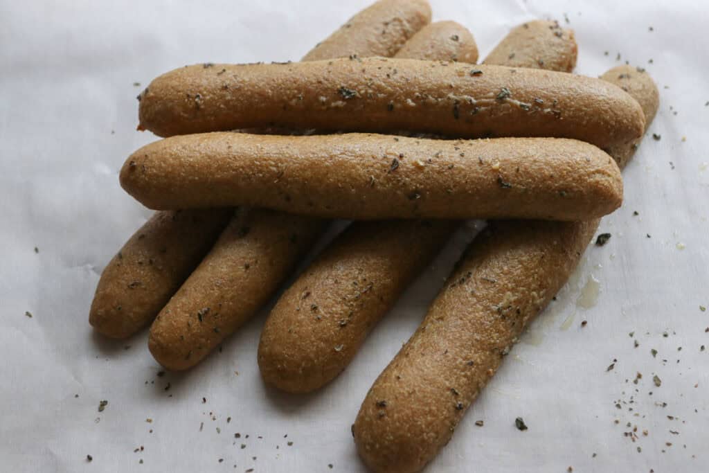 fresh milled sourdough breadsticks covered with garlic butter and stacked together