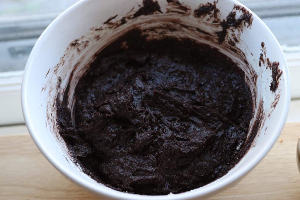 freshly milled fudgy cosmic brownie batter in a white bowl