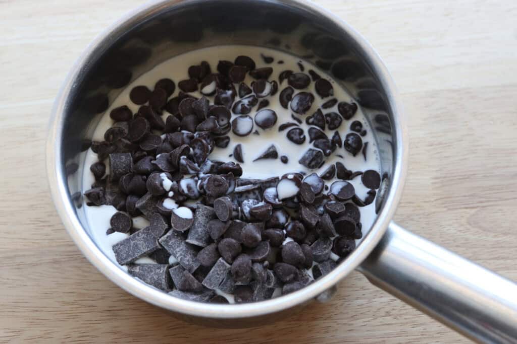 chocolate chips and heavy cream in a saucepan to make the ganache for freshly milled fudgy cosmic brownies