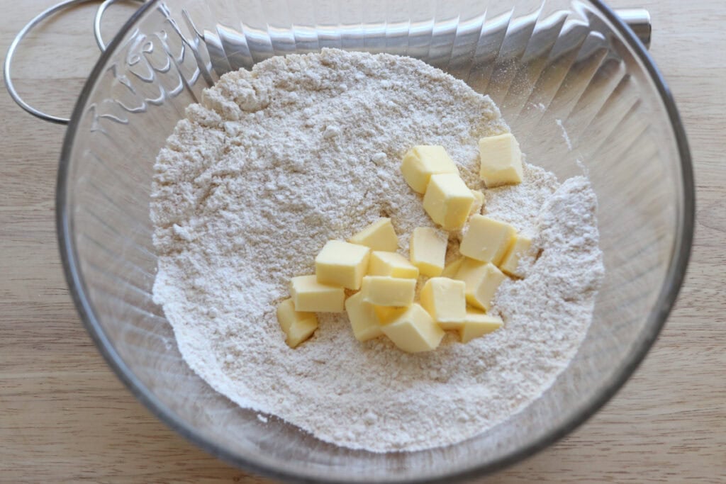cubed butter in a bowl to make crisp and flaky fresh milled ritz crackers