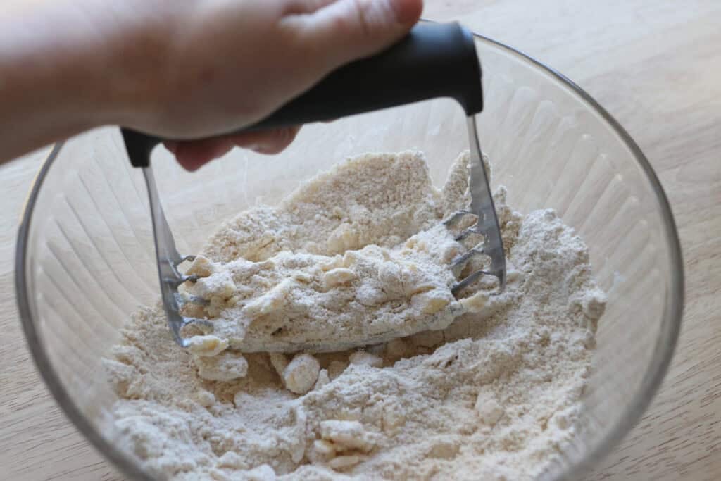 cutting the butter into the flour to make crisp and flaky fresh milled ritz crackers