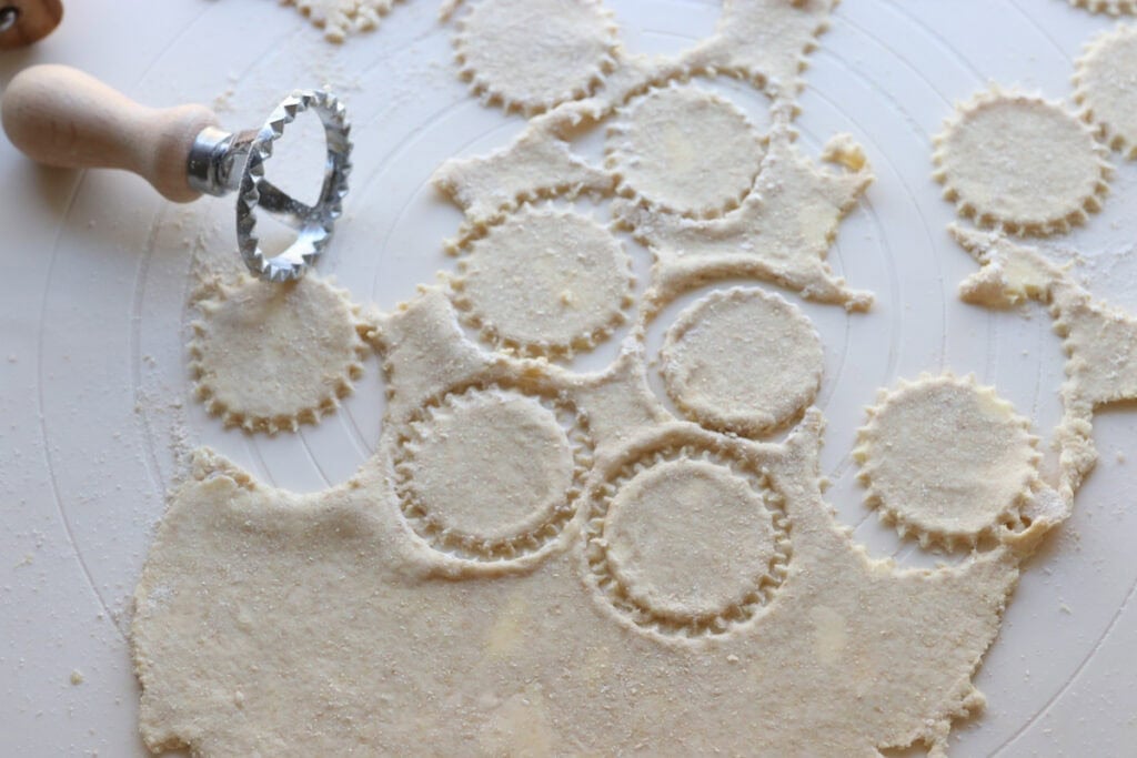 crisp and flaky fresh milled ritz cracker dough that has been cut out into circles