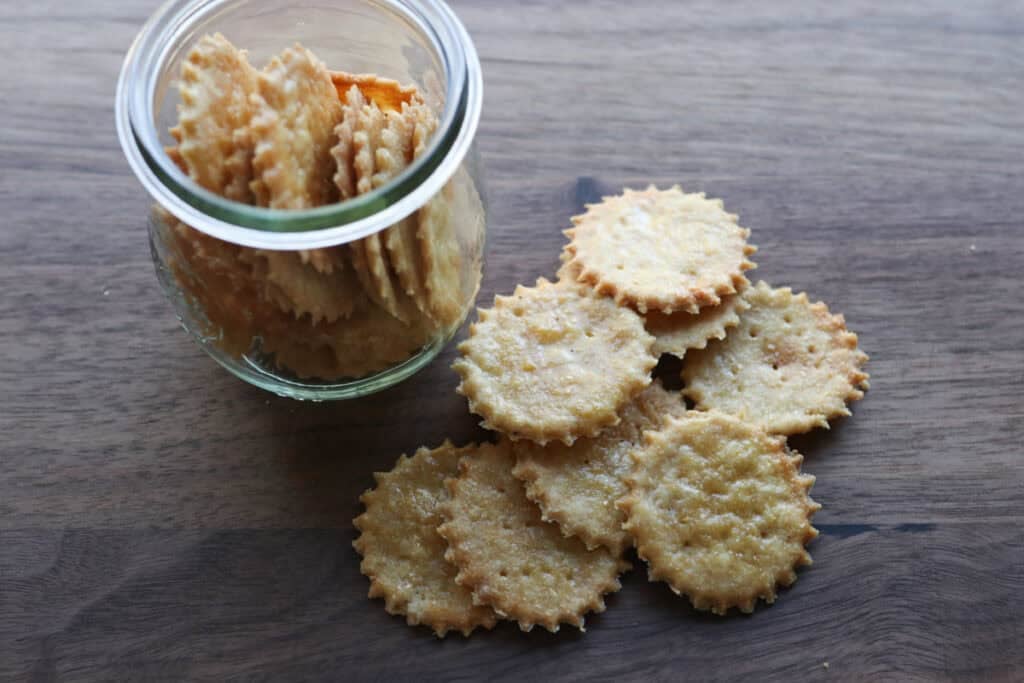 crisp and flaky fresh milled ritz crackers on a wooden cutting board
