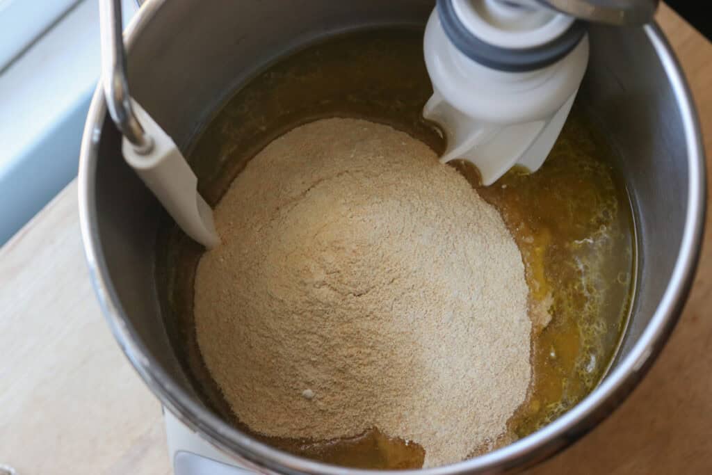 flour, oil, honey, and lemon juice in a bowl to make the dough for Freshly Milled Valentine's Strawberry Cinnamon Rolls