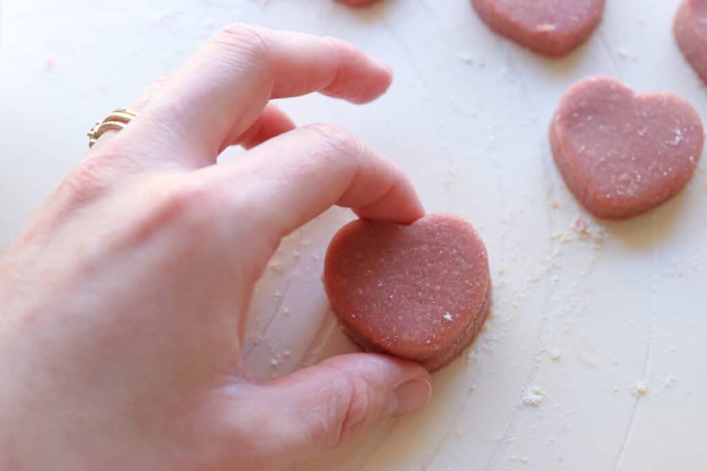 stacking together pink hearts to make Freshly Milled Slice and Bake Valentine's Cookies
