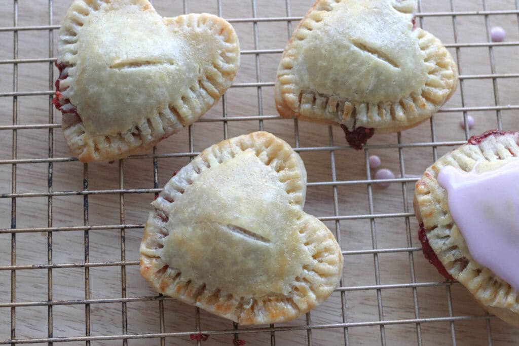Fresh Milled Homemade Valentine's Strawberry Poptarts cooling on a wire rack