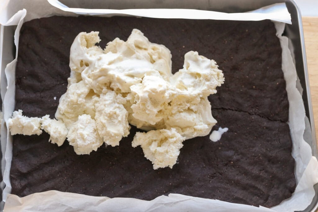 ice cream that has been scooped on to of a freshly milled ice cream sandwich cookie base