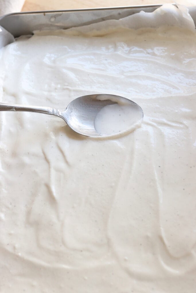 spreading ice cream onto the Homemade Ice Cream Sandwiches with Fresh Milled Flour