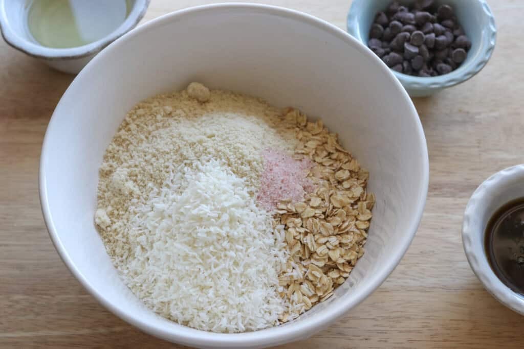 oats, coconut, and almond flour in a bowl to make Easy and Delicious Copycat Heavenly Hunk Squares
