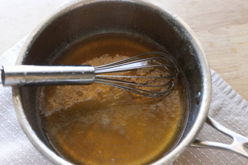 honey and water in a saucepan to make homemade marshmallow fluff