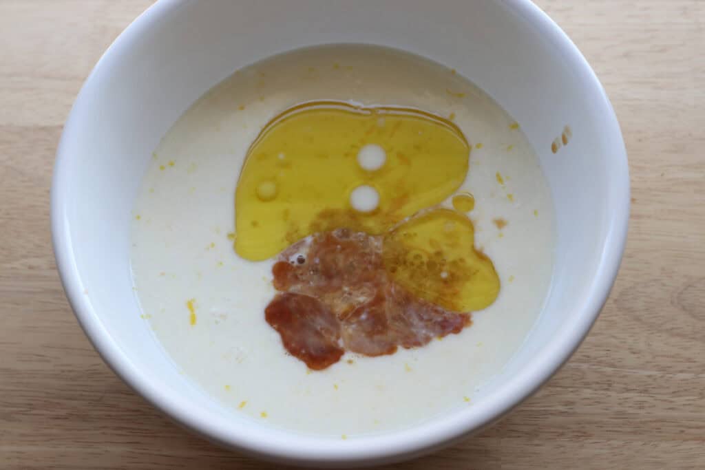 oil and eggs in a white bowl to make Freshly Milled Fluffy Lemon Blueberry Pancake Bites