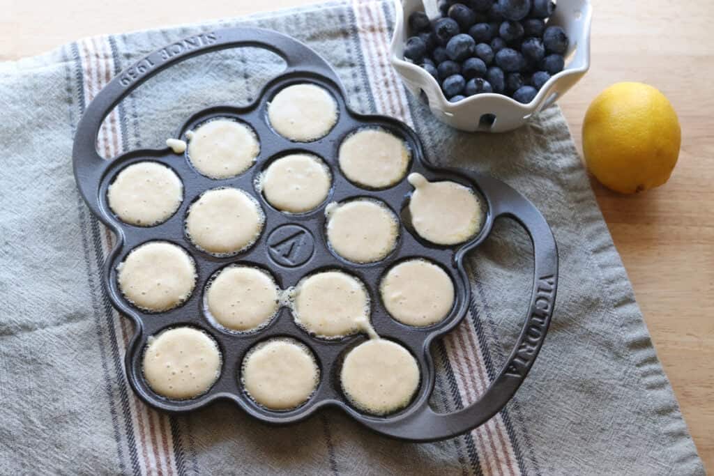 Freshly Milled Fluffy Lemon Blueberry Pancake Batter divided into an ebelskiver pan 