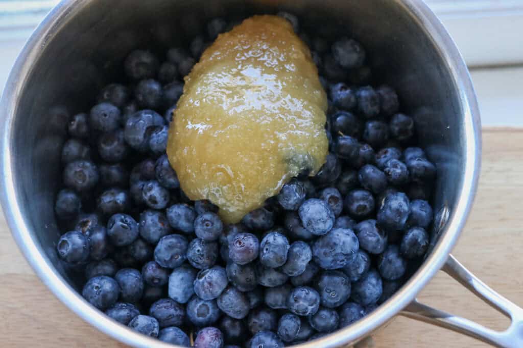 blueberries and honey in a sauce pan to make The Best Blueberry Pie Bars with Fresh Milled Flour