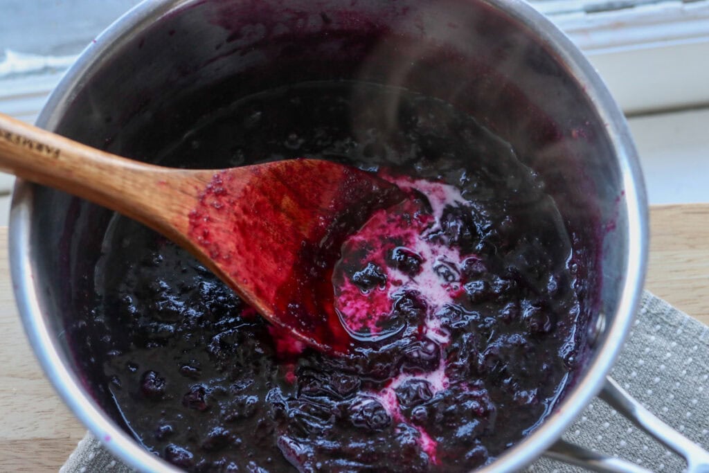 blueberries and cornstarch in a pot to simmer to make The Best Blueberry Pie Bars with Fresh Milled Flour