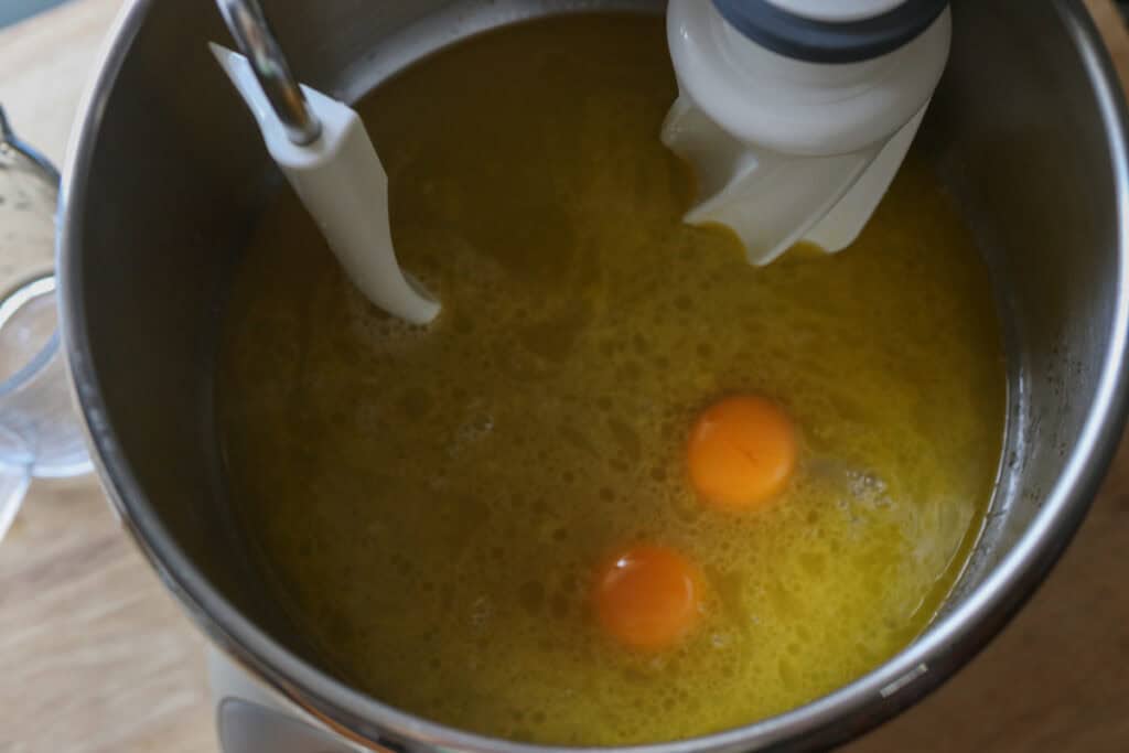 honey, butter, and eggs in a mixing bowl to make freshly milled braided challah bread