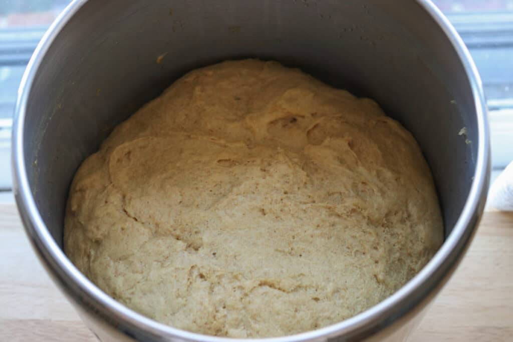freshly milled braided challah bread dough that has doubled in size