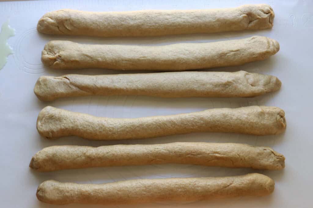freshly milled braided challah dough rolled into 6 pieces