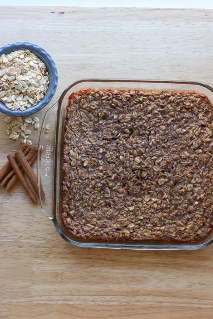 healthy and homemade chai baked oatmeal with oats in a bowl and cinnamon sticks