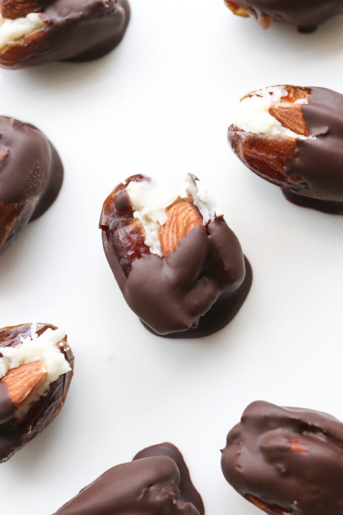 healthy almond joy dates that have been filled with almonds and coconut and dipped in chocolate