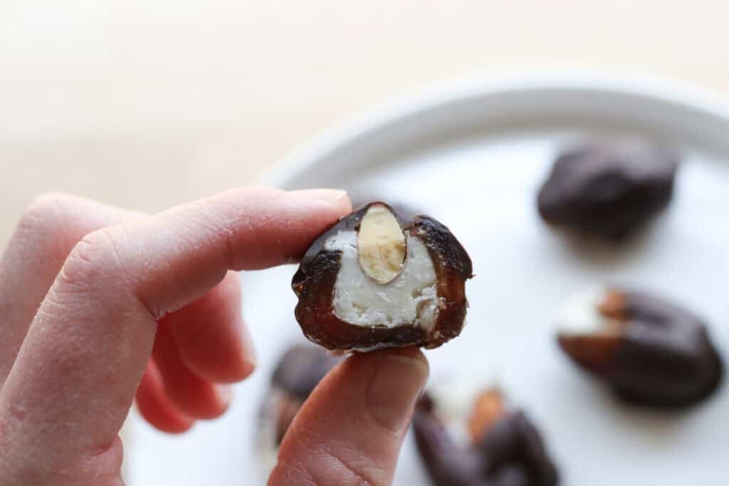 someone holding a Chocolate Covered Almond Joy Stuffed Date 